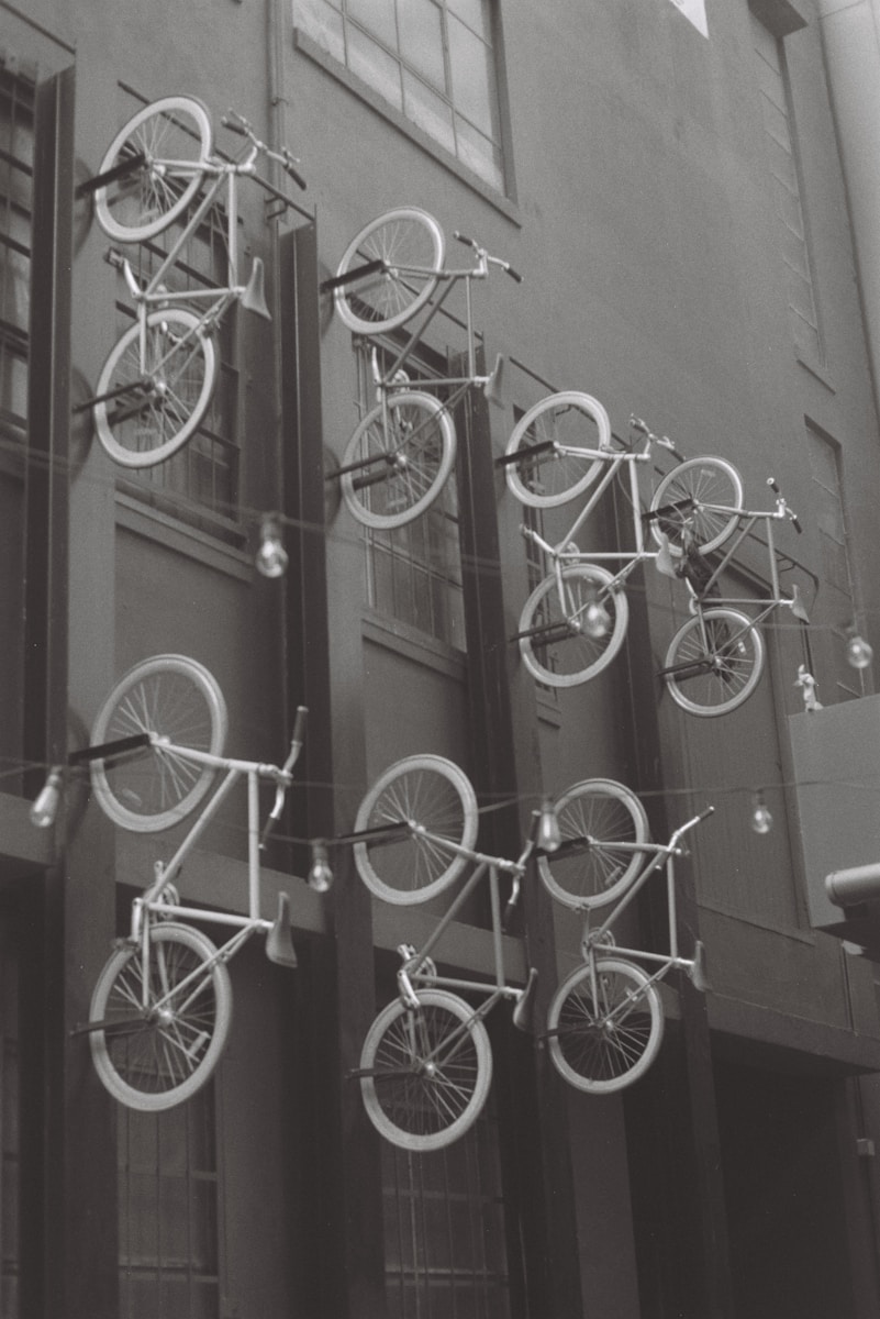 A black and white photo of a building with bicycles on it
